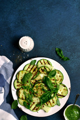 Grilled zucchini with mozzarella cheese and basil pesto. Top view with copy space.