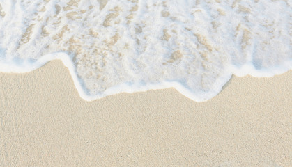 Fototapeta na wymiar Close-up of white sand, washed by soft sea waves