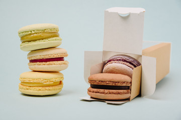 Several colorful macaroon cakes on a colored background