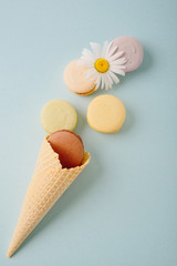 Several colorful macaroon cakes on a colored background
