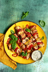 Grilled chicken kebab with vegetable and yogurt sauce. Top view with copy space.