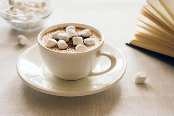 Still life with a Cup of coffee, marshmallow and a book. The concept of morning mood.