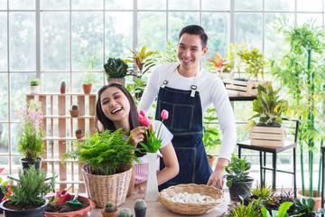 Beautiful portrait young asian woman and handsome man harvest and picking up fresh potted plant...