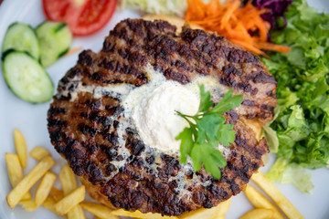 Delicious and juicy hamburger patty on a plate