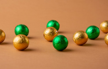 Chocolate balls in colored foil. New Year and Christmas background