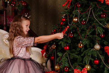 a cute little girl in a dress getting ready for New Year's.