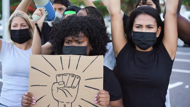 People from different culture and races protest on the street for equal rights - Demonstrators wearing face masks during black lives matter fight campaign - 4K