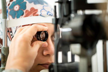 A woman checking her eyes at an ophthamology center