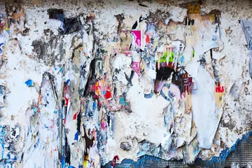Foto auf Acrylglas Creative abstract background. Old rough surface of a dilapidated building with traces of old cracked paint and remnants of paper advertising. © Elena