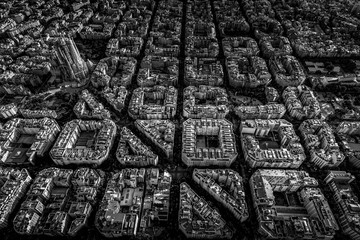 Aerial view of typical buildings of Barcelona cityscape from helicopter with Sagrada Familia. in...