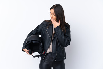 Young brunette woman with a motorcycle helmet over isolated white background with surprise and shocked facial expression