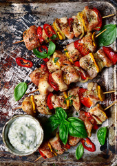 Roasted chicken kebab on a metal baking sheet. Top view with copy space.