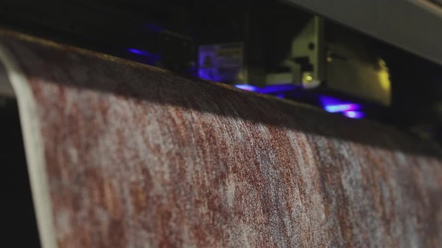 Modern wallpaper factory. Industrial printer making new wallpaper sample. Wallpaper production. One of step creation new wallpaper. Closeup