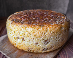 Large round bread with sunflower and sesame seeds close up