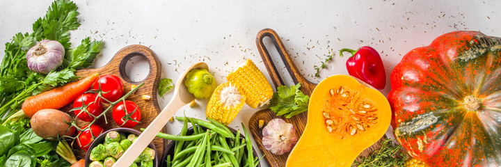 Autumn cooking background. Organic autumn harvest vegetables, raw vegan ingredients for cooking traditional thanksgiving and fall food on white background, top view