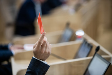 Red card in hand, man votes, adoption of the bill
