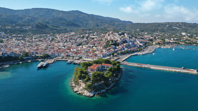 Aerial drone panoramic photo of picturesque main town of Skiathos island featuring small landmark peninsula of Bourtzi, Sporades, Greece © aerial-drone