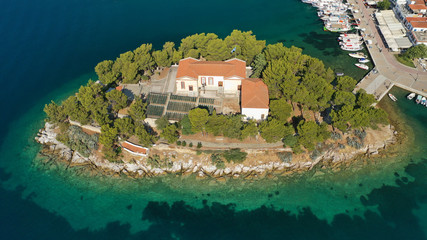 Aerial drone photo of amazing vegetated islet of Bourtzi built in small peninsula in port of Skiathos island main town hosting an old school, Sporades, Greece