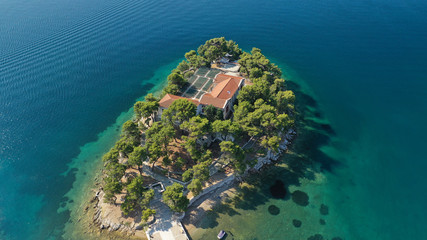 Aerial drone photo of amazing vegetated islet of Bourtzi built in small peninsula in port of Skiathos island main town hosting an old school, Sporades, Greece