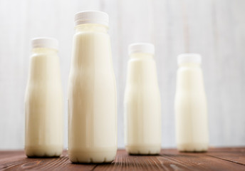 Bottles with milk, yogurt on a light background. Natural dairy products.