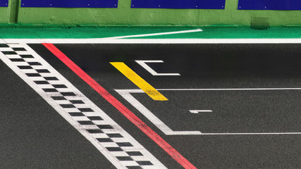 The finish line of a racing track with the number one written on the asphalt , symbol of the goal...