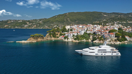 Aerial drone panoramic photo of picturesque main town of Skiathos island featuring small landmark peninsula of Bourtzi, Sporades, Greece