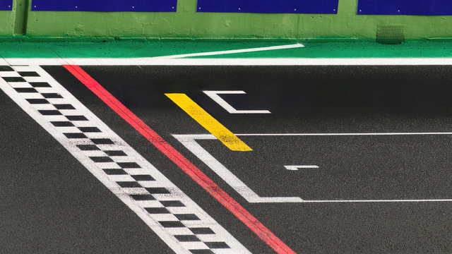The finish line of a racing track with the number one written on the asphalt , symbol of the goal to reach