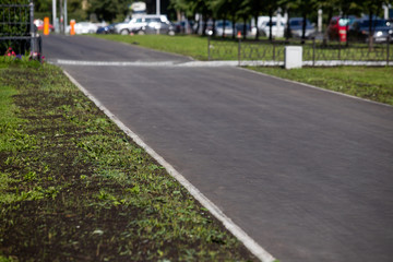 Fototapeta premium New asphalt on the sidewalk, renovation completed