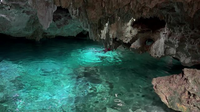 Tourist is swimming in the Zacil Ha cenote (Clear Water). Kantun-Chi Ecopark, Mexico
