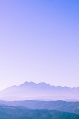 Surreal mountain landscape, purple neon pale mountains and sky, creative inspiration nature concept