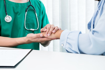 Male doctors use a friendly hand to shake hands, female patients, to give confidence and show care about health care. Medical concepts and good health