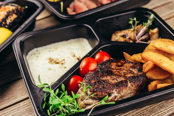 group of food in plastic dish on table. take away food