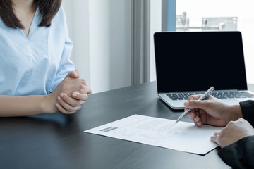 Business people hold a resume and talk to job applicants for job interviews about careers and Her...