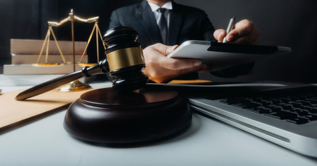 Business and lawyers discussing contract papers with brass scale on desk in office. Law, legal services, advice, justice and law concept picture with film grain effect