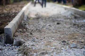 Naklejka premium Reconstruction of the sidewalk and replacement of old curbs. Construction zone