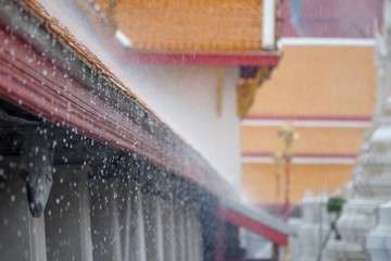 roof of temple thailand with rain falling