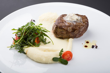 Fried beef steak served with mashed potatoes