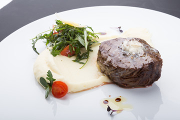 Fried beef steak served with mashed potatoes
