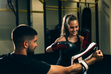 woman training kick box with his personal trainer