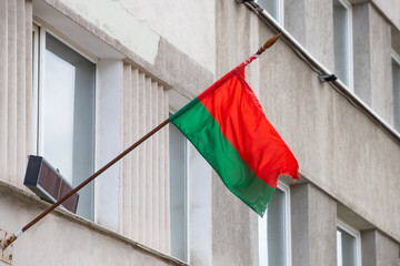 National flag and coat of arms of the republic of Belarus on the building.