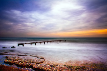 Obraz premium Old Worn Pier Columns, Logs of remains of the old, wooden pier, in the sea