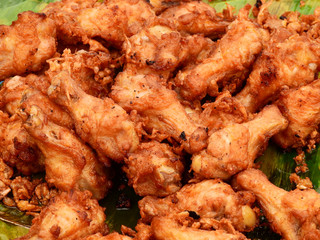 Fried chicken calves on banana at street food Thailand