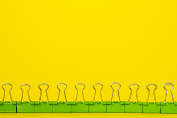 green stationery binders on yellow background