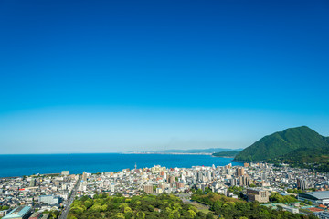 Cityscape view of Beppu city and Beppu bay with blue sky background, Oita, Kyushu, Japan