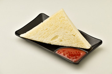 triangle white bread sandwich with sauce isolated on white background