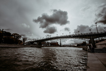 iron bridge over the river in cloudy gloomy weather