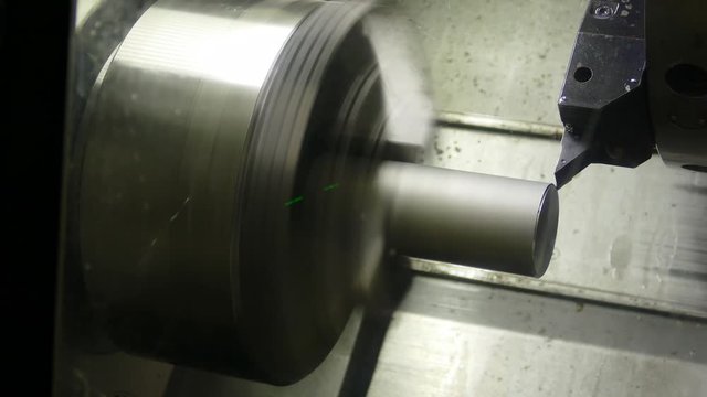 the CNC machine grinds the metal part, video