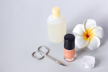 nail polish scissors rub for manicure and a flower on a  gray background, nail care manikure and pedicure at home or in a spa salon procedures