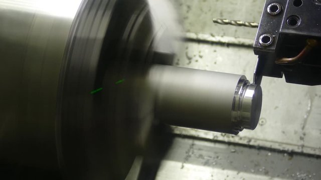 the CNC machine grinds the metal part, video