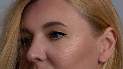 Close-up of a beautiful woman's eye with lashes and long eyelashes and perfect skin thanks to youth-preserving creams and cream contour against aging and wrinkles on the eyes.